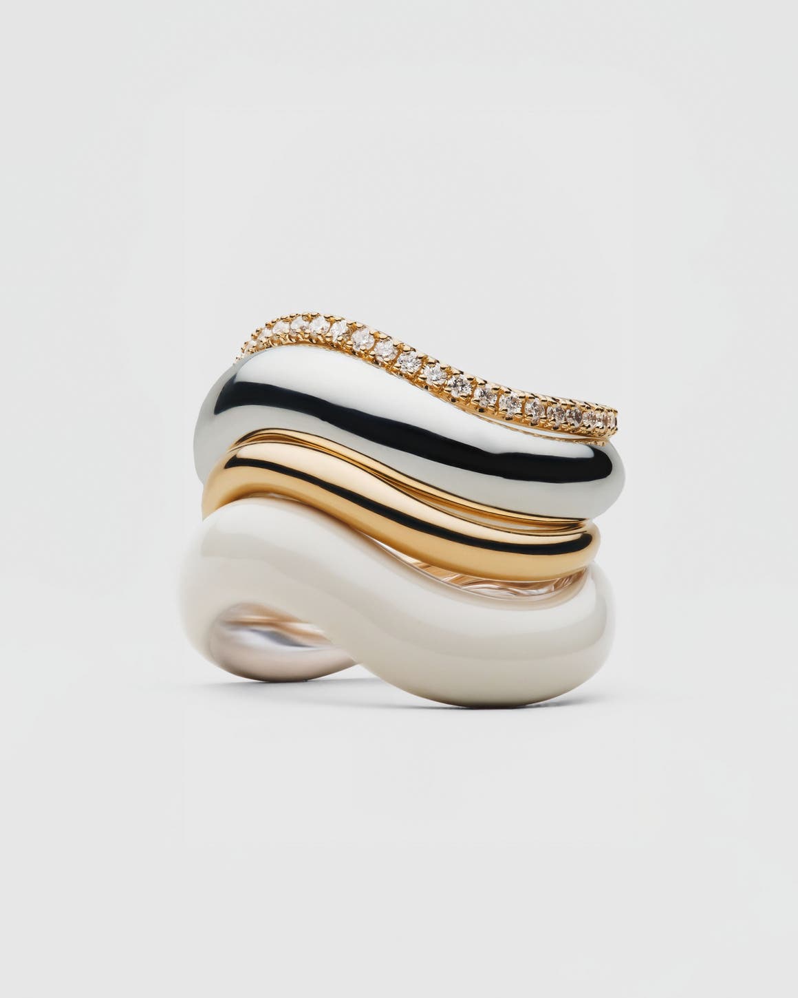 A stack of gold and diamond rings.