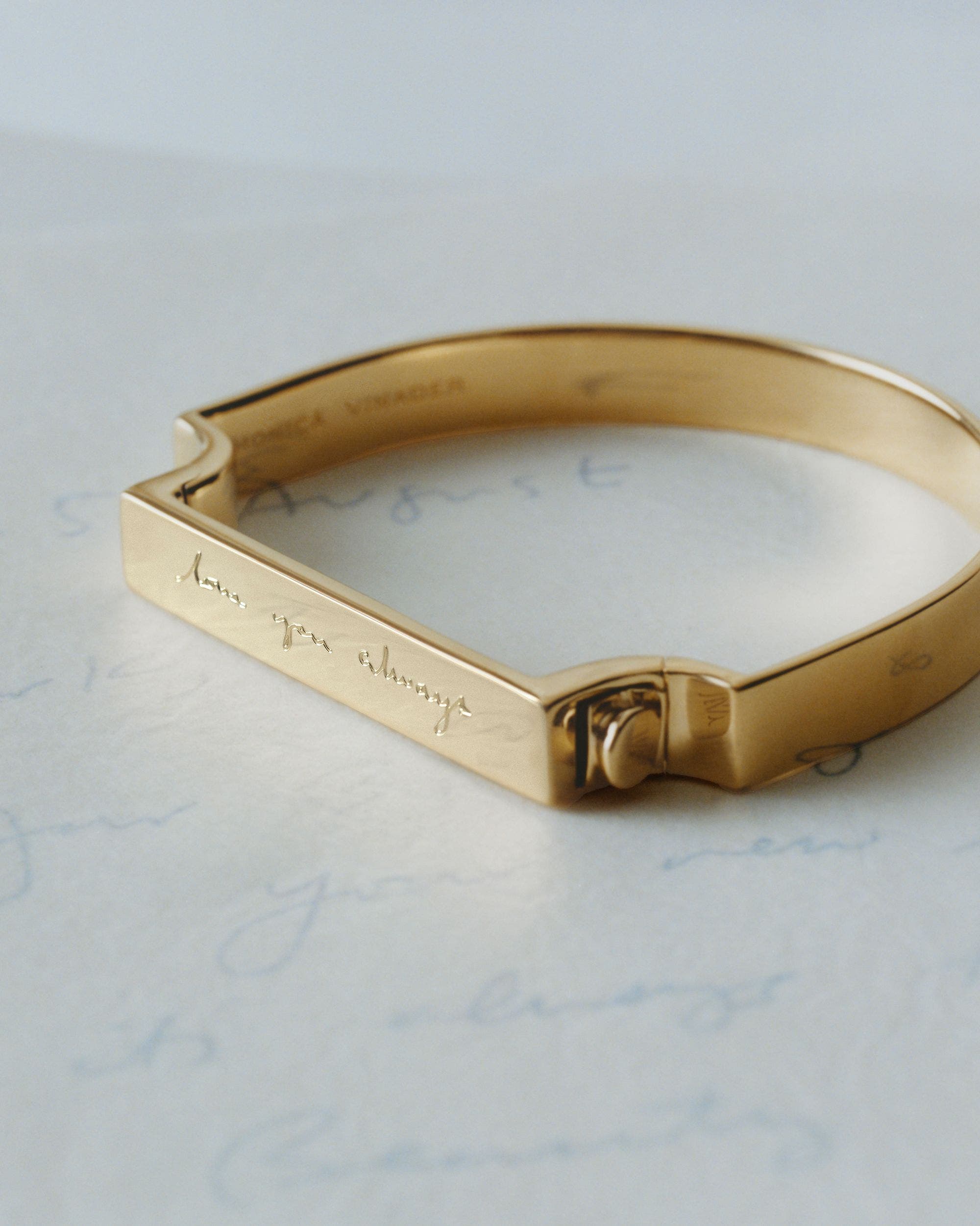 N125 exclusive; an engraved gold bracelet and pendant.