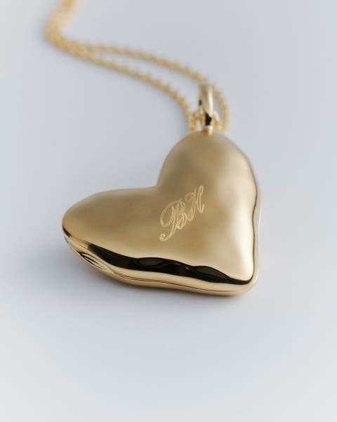 Gold engraved Monica Vinader heart charm.