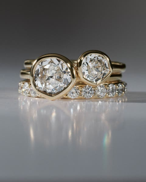Diamond Monica Vinader rings stacked on top of each other.