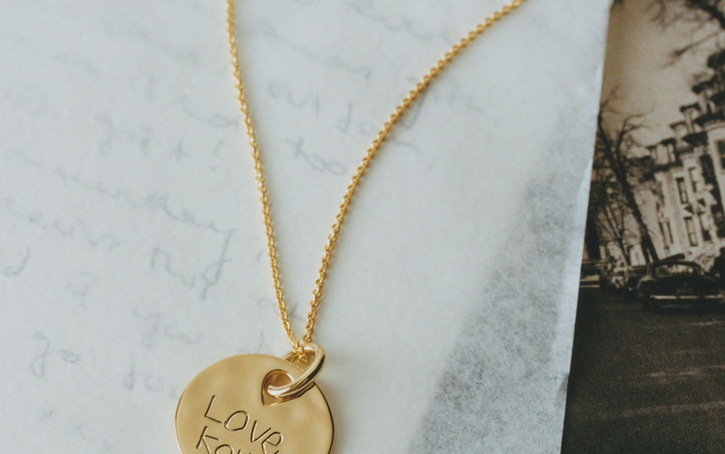 A gold necklace with custom engraving.