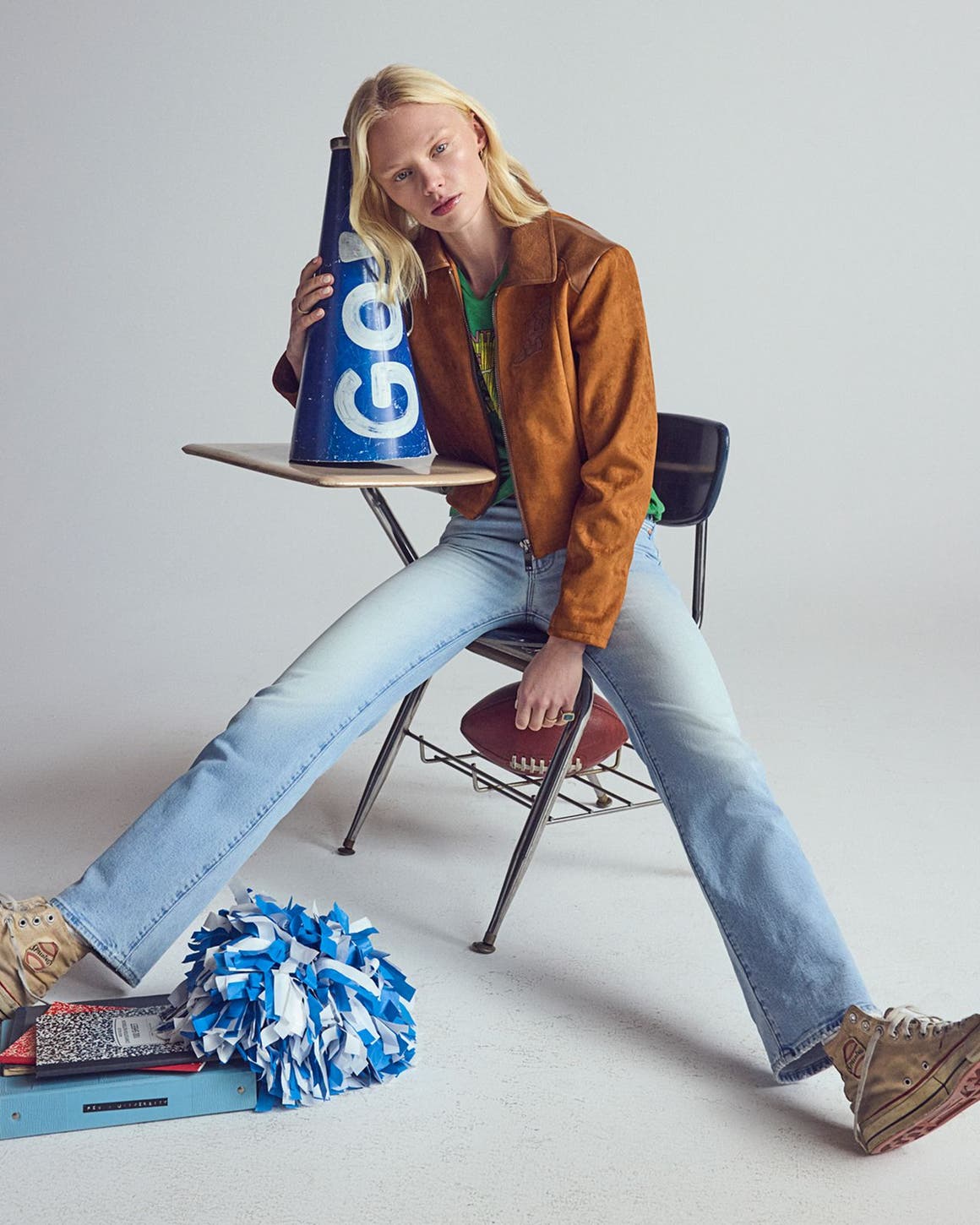 A woman wearing a suede jacket & denim.