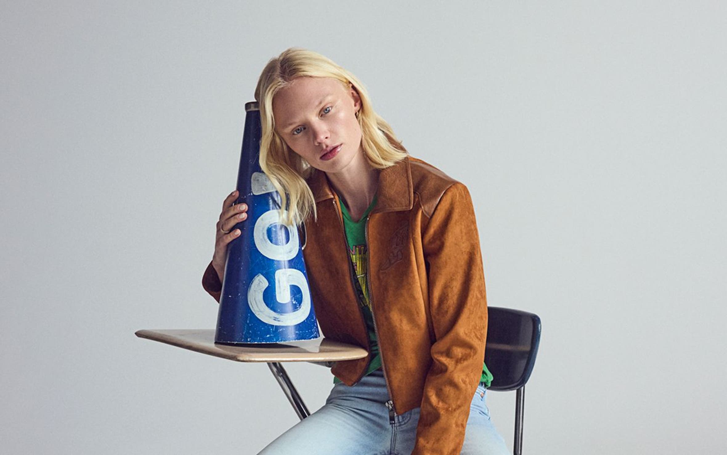 A woman wearing a suede jacket & denim.