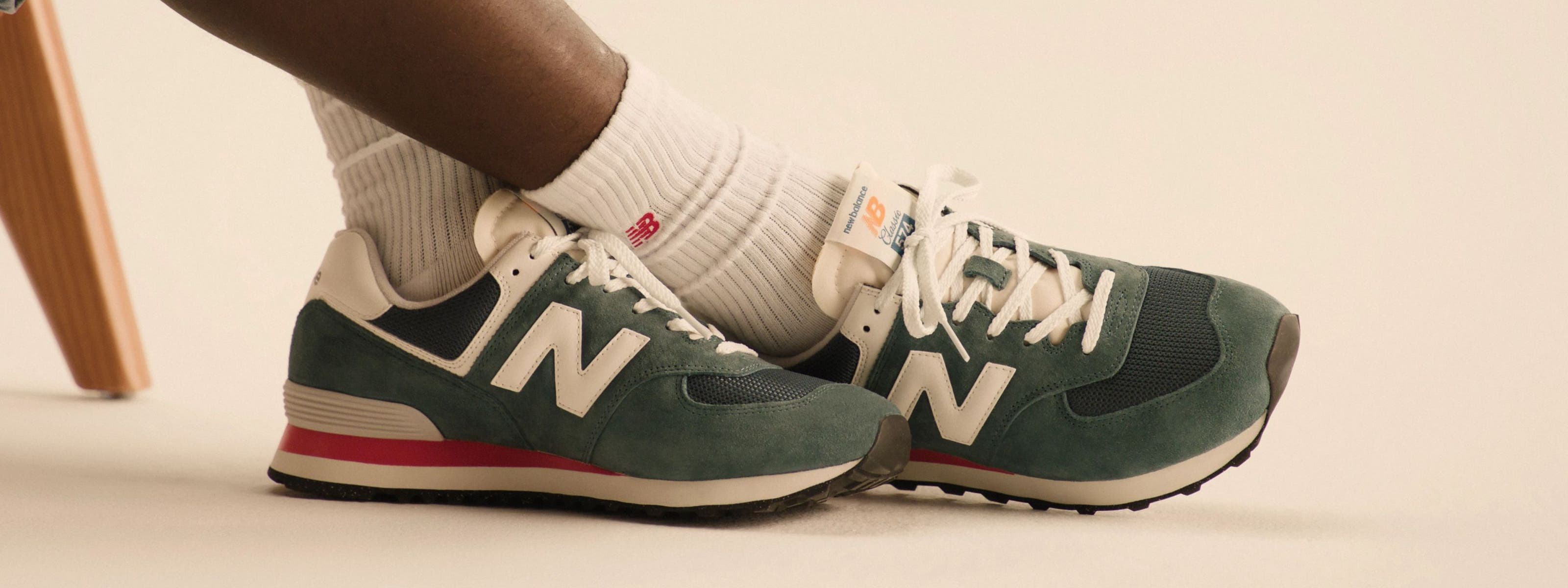 Model wearing crew socks and athletic sneakers from New Balance.