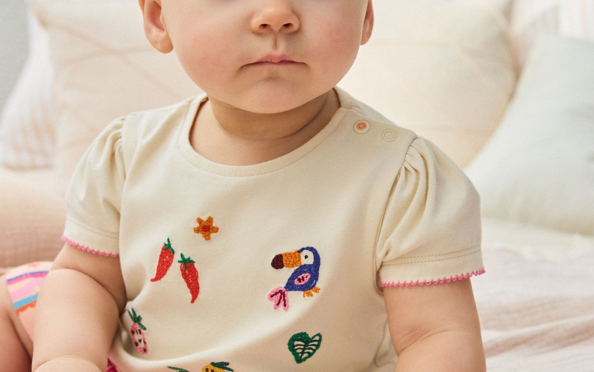 A baby girl wearing an outfit by NEXT.