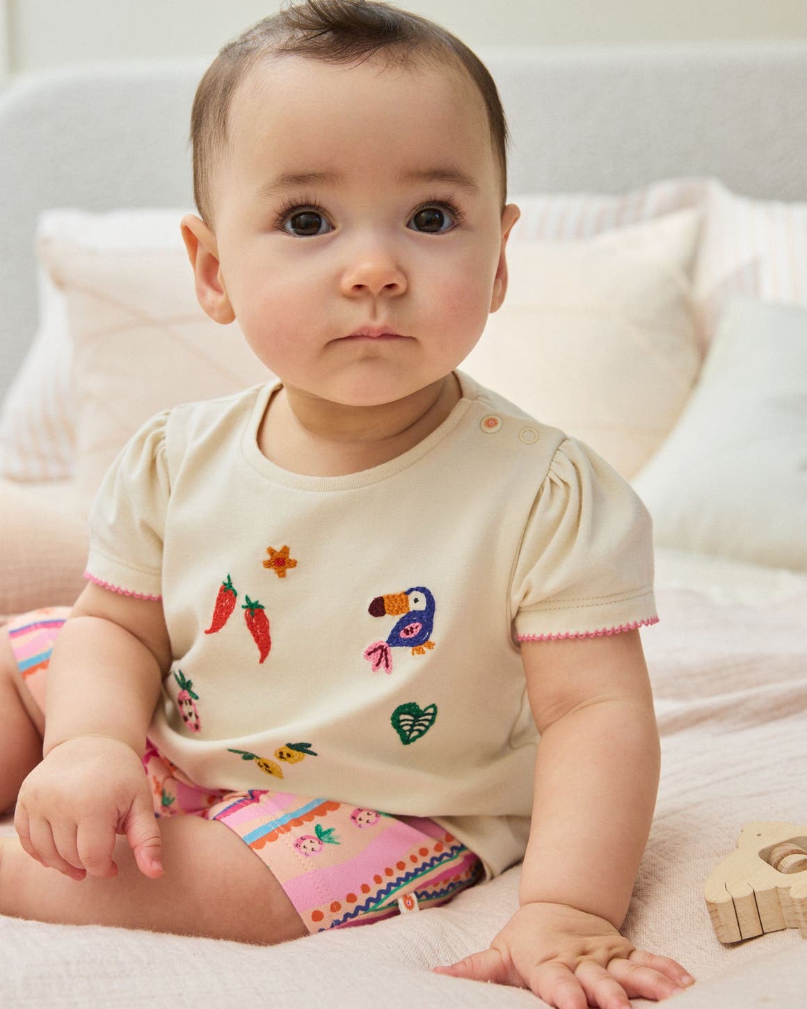 A baby girl wearing an outfit by NEXT.