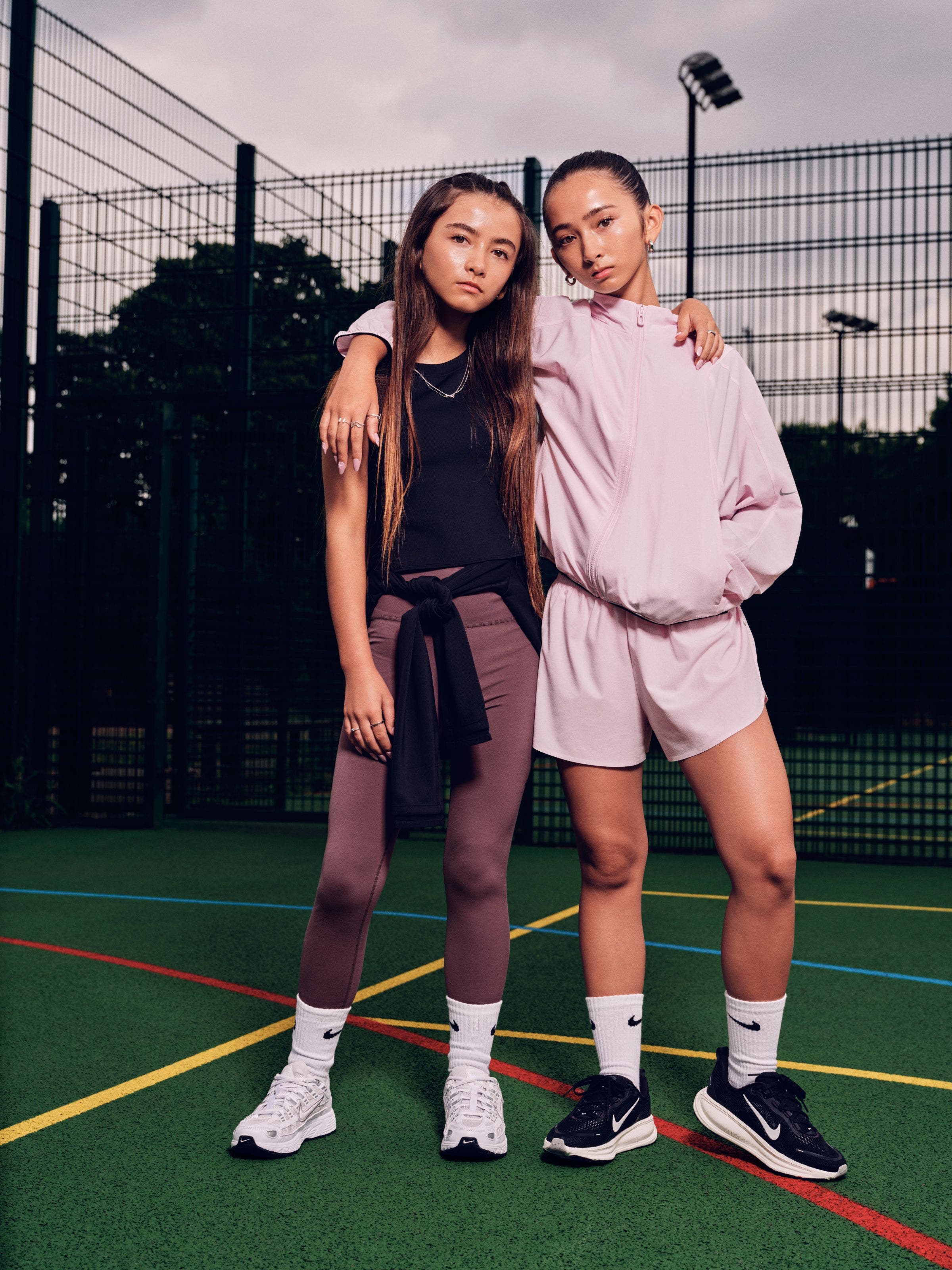 Two teen girls wearing Nike MAVN clothing.