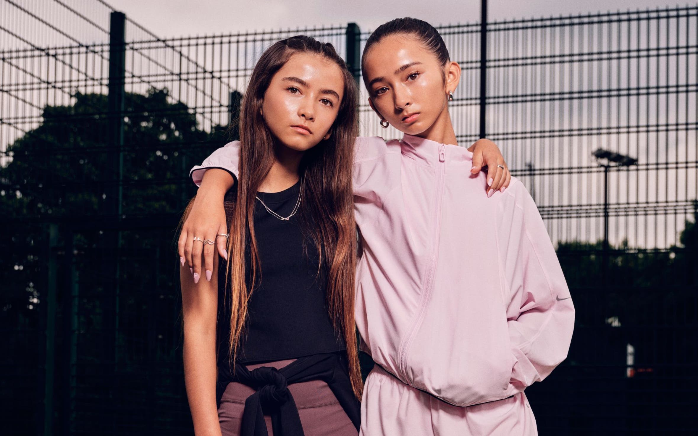 Two teen girls wearing Nike MAVN clothing.
