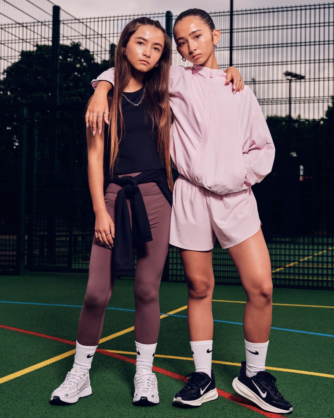 Two teen girls wearing Nike MAVN clothing.