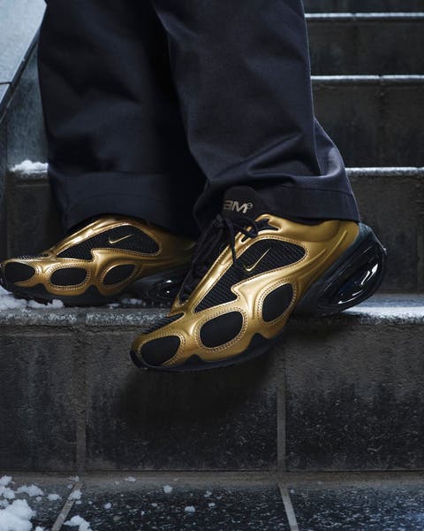 Gold and black Nike shoes