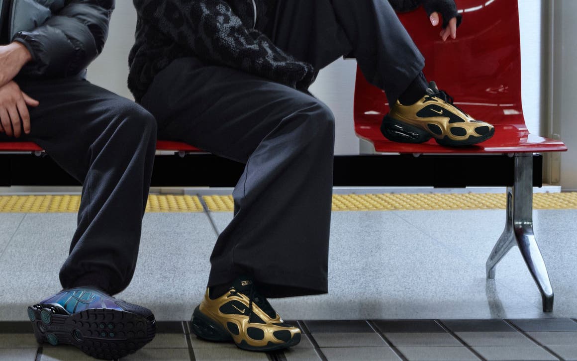 Two models wearing Nike shoes sitting on a bench