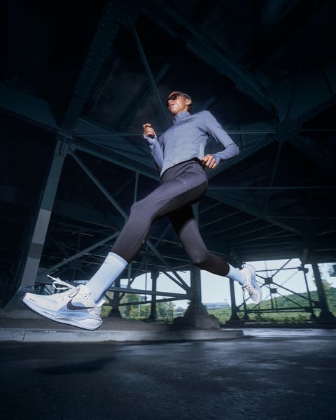 Woman wearing activewear and Nike running shoes.