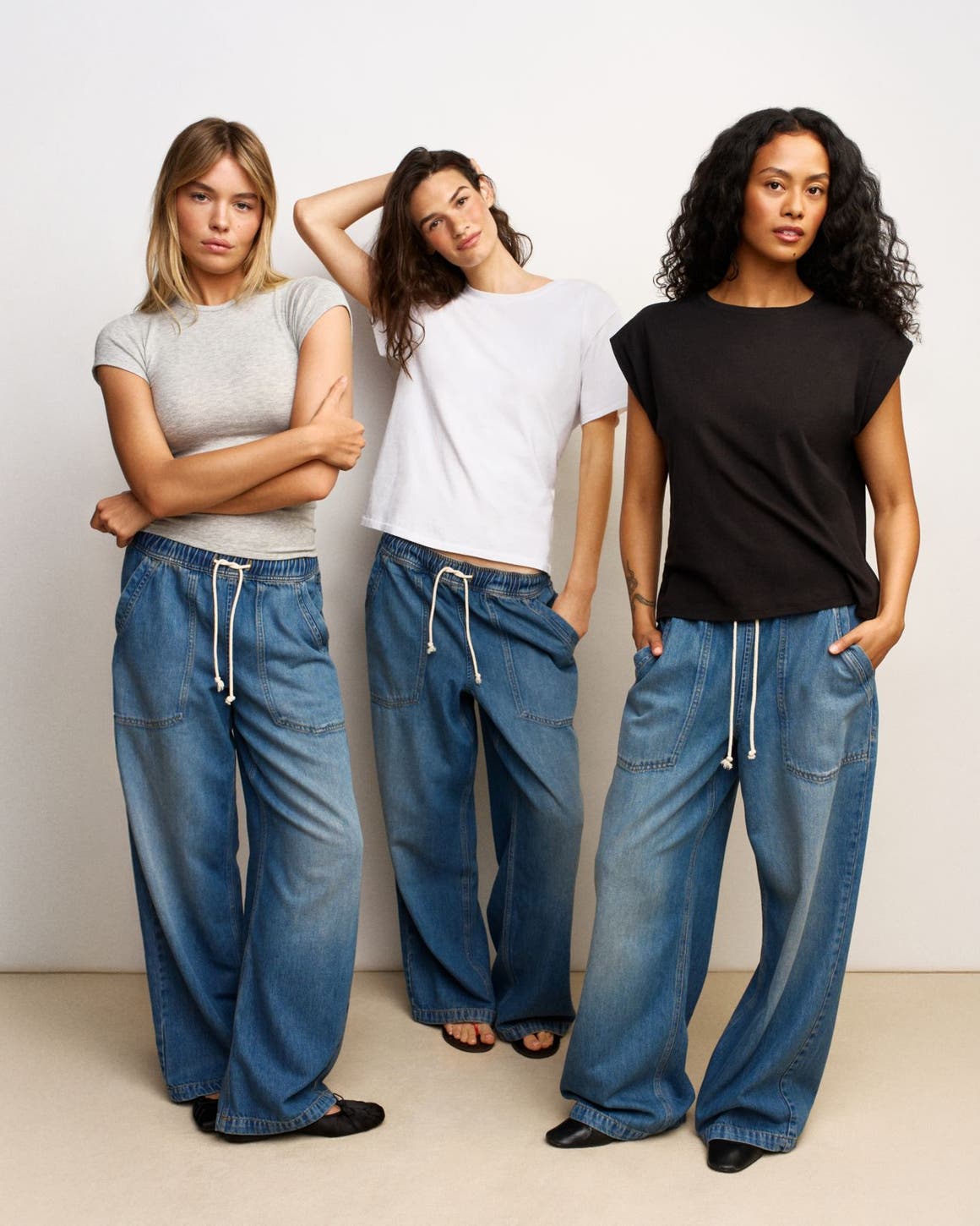 Three women wearing tees and pull-on jeans.