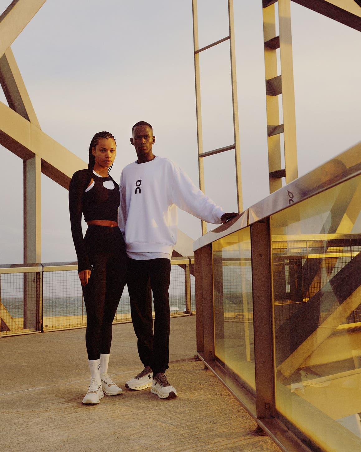 Woman and man wearing athletic apparel and sneakers from On.