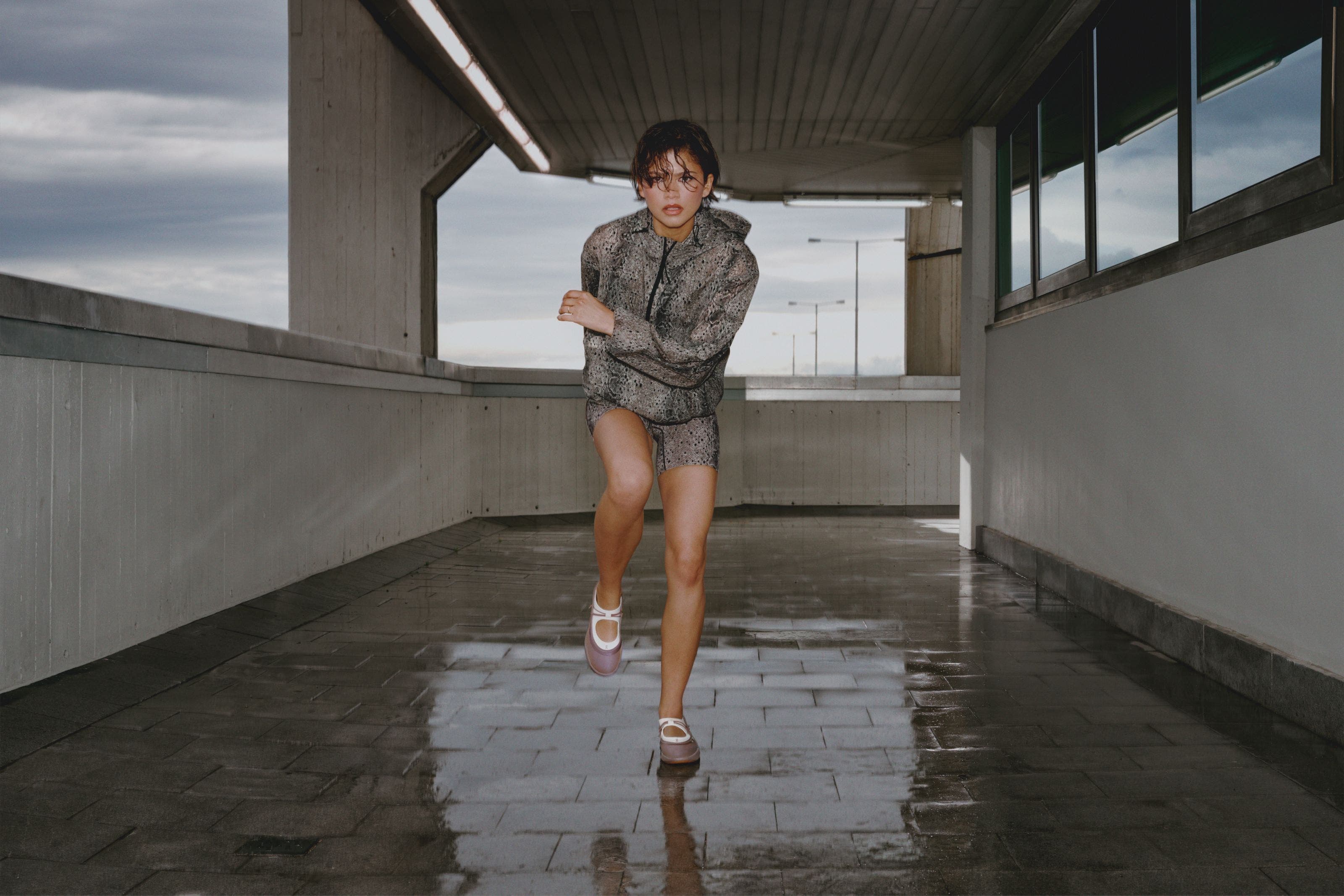 Zendaya wearing a snakeskin printed workout set and On mary janes.