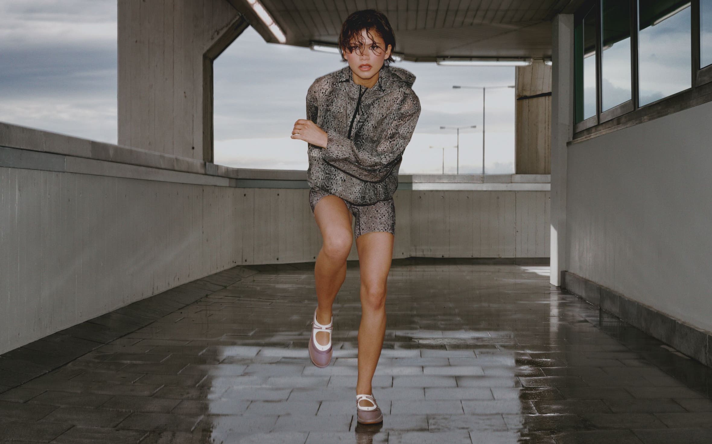 Zendaya wearing a snakeskin printed workout set and On mary janes.
