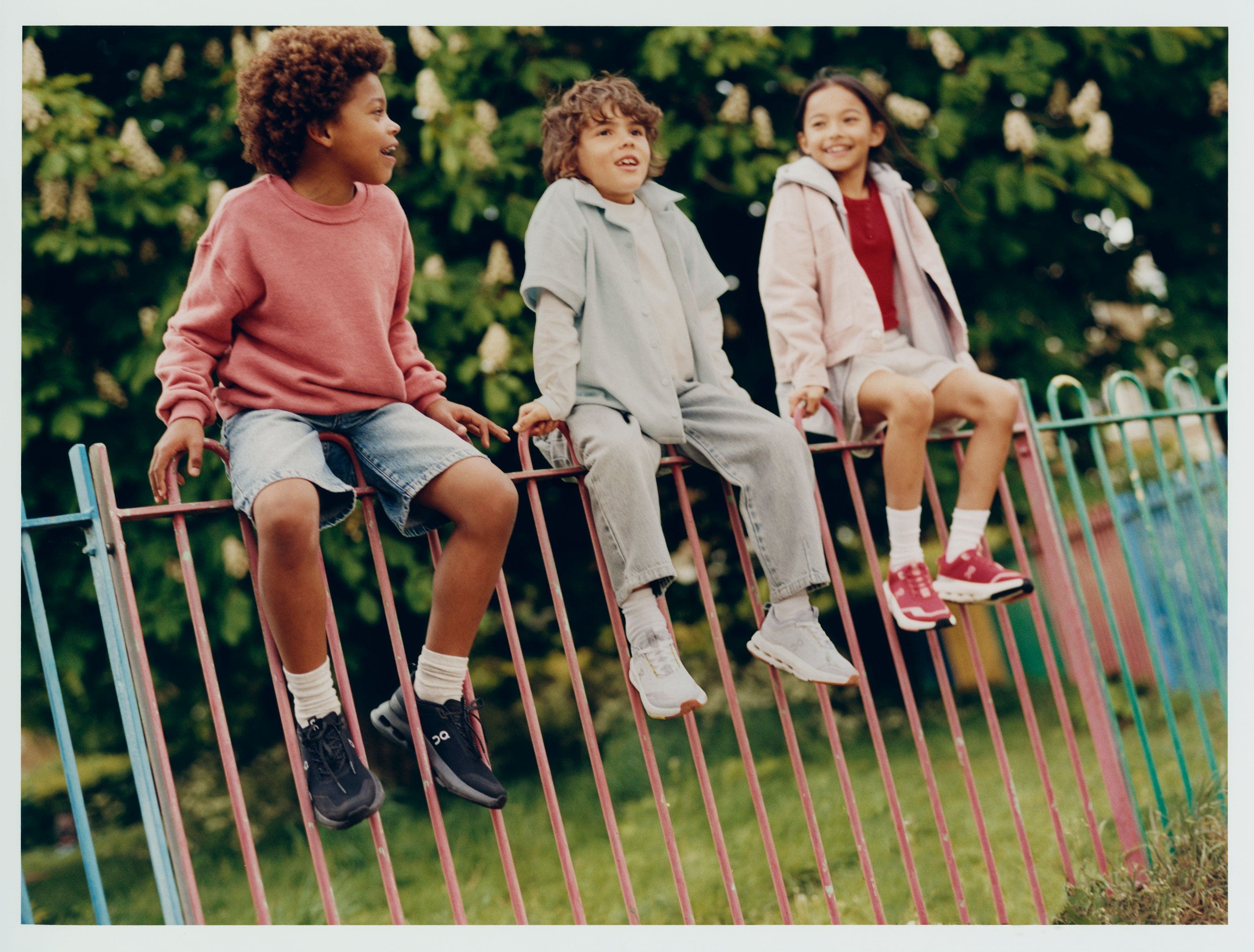 3 kids wearing On running shoes.