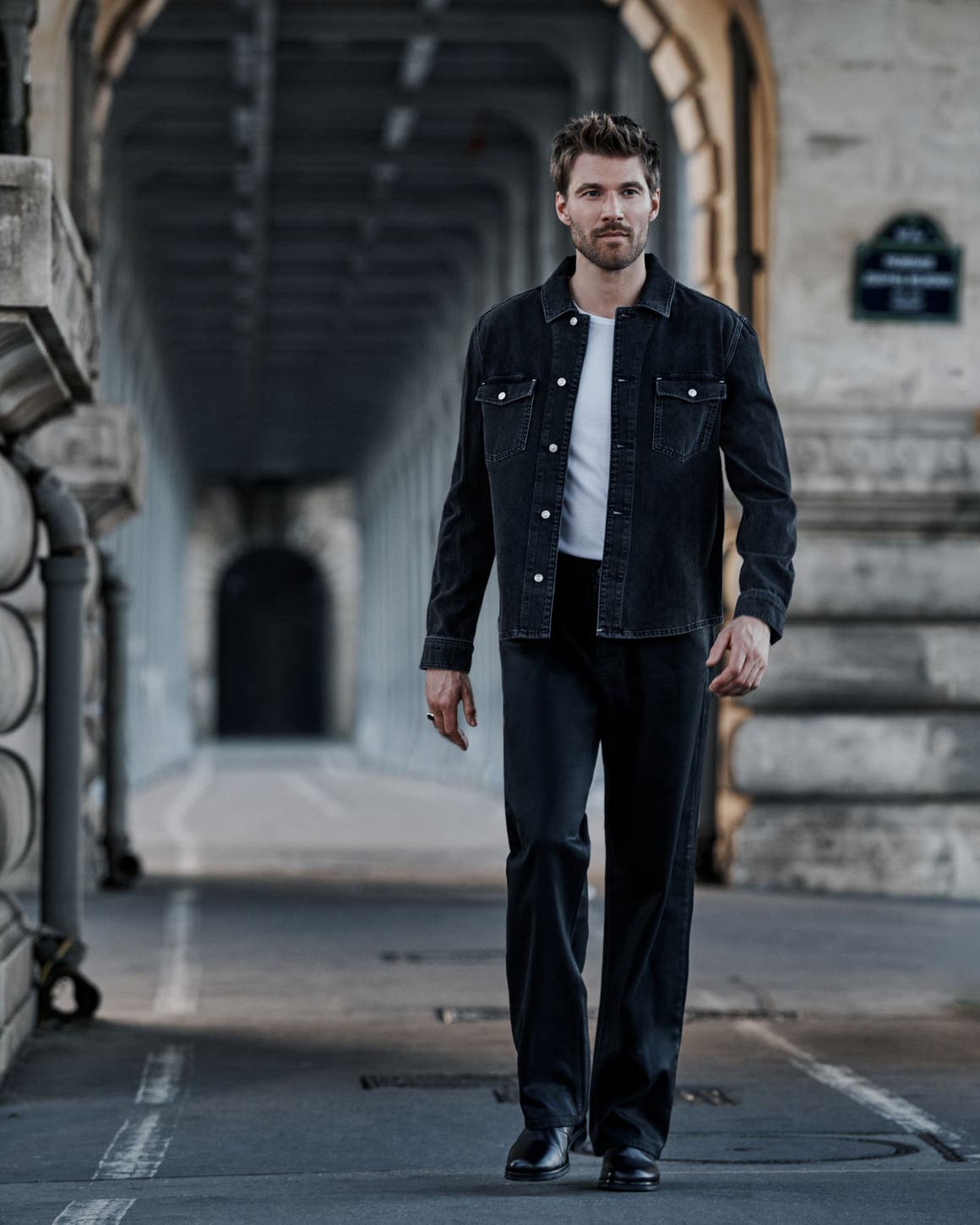 A man wearing PAIGE denim jacket and jeans.
