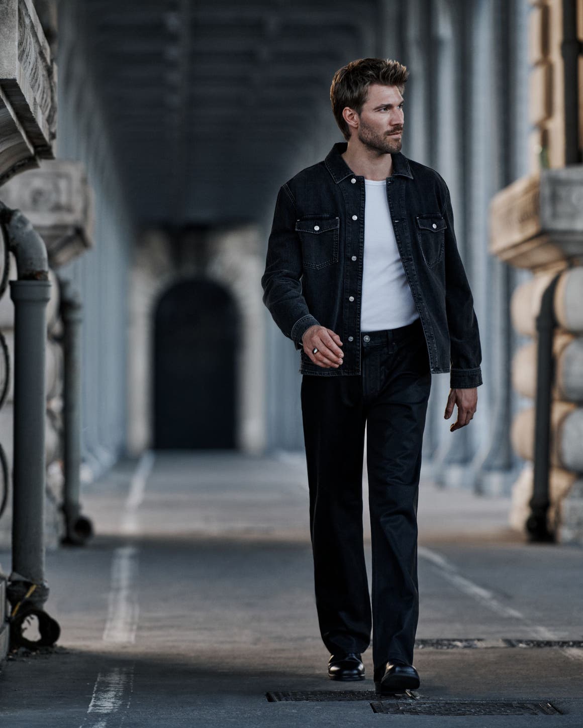 A man wearing PAIGE denim jacket and jeans.