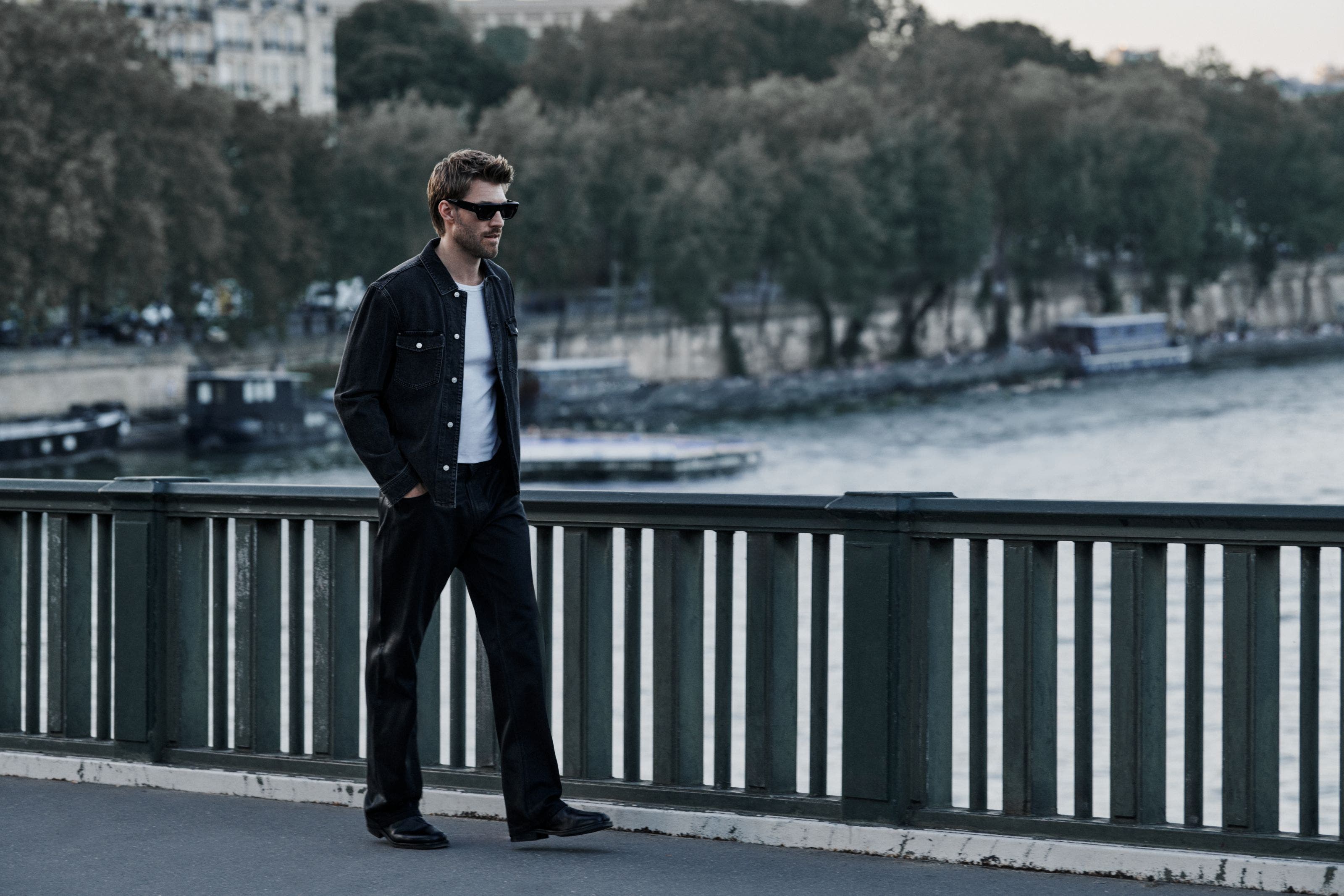 A man wearing PAIGE denim jacket and jeans.