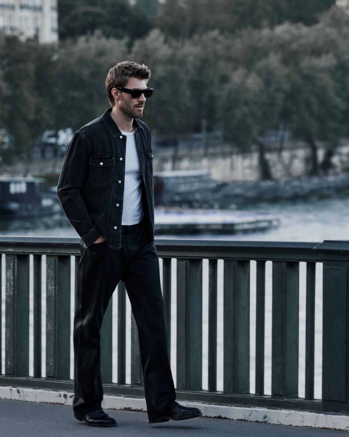 A man wearing PAIGE denim jacket and jeans.