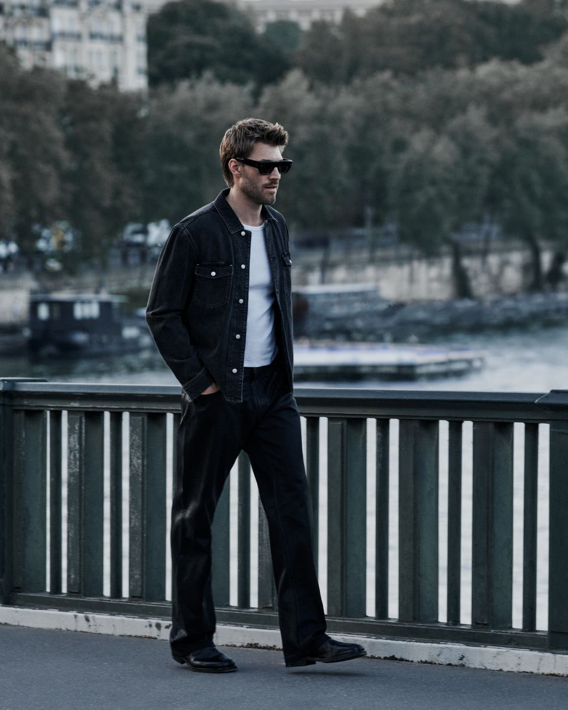 A man wearing PAIGE denim pants and jacket.