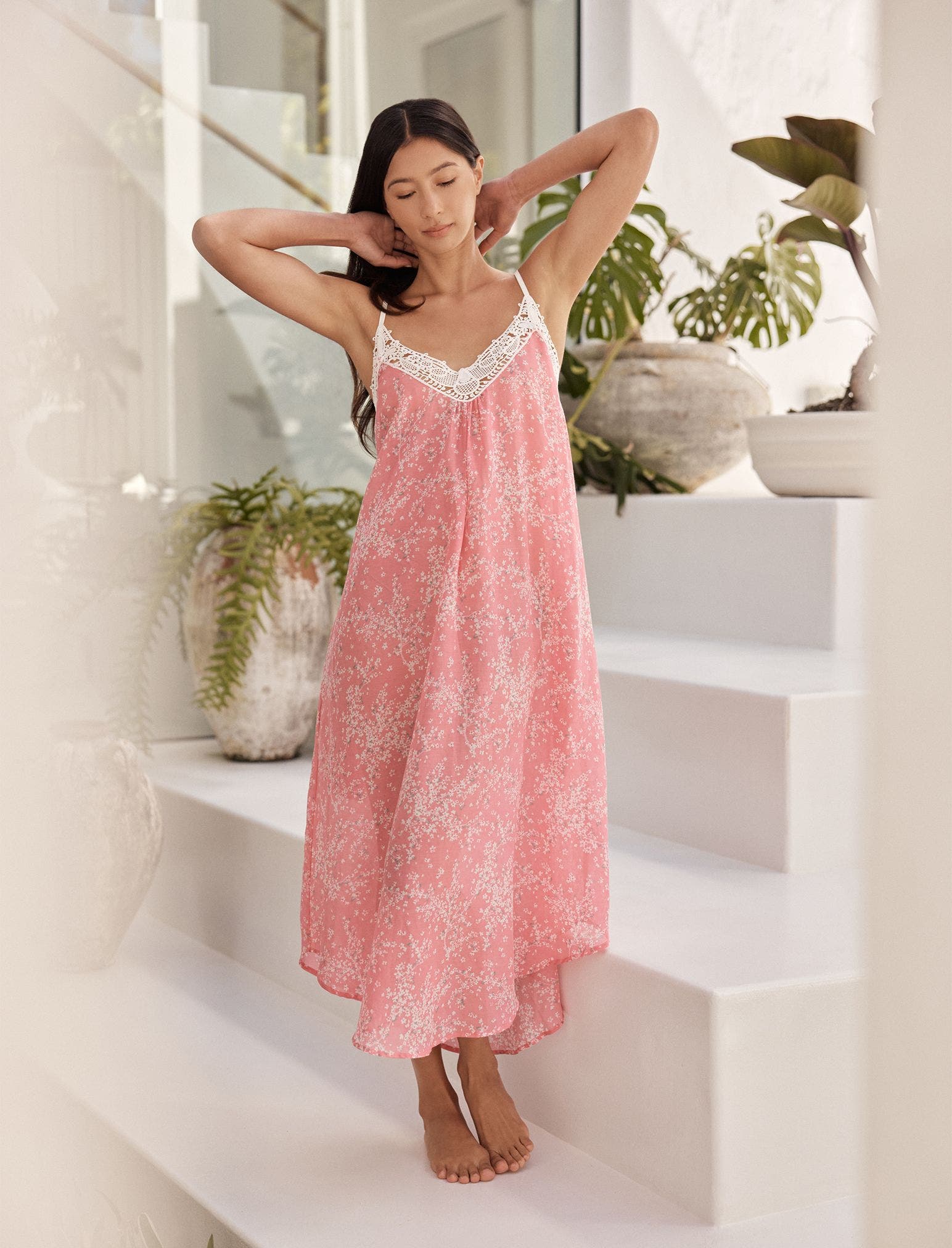 Woman wearing pink floral tank night dress. 