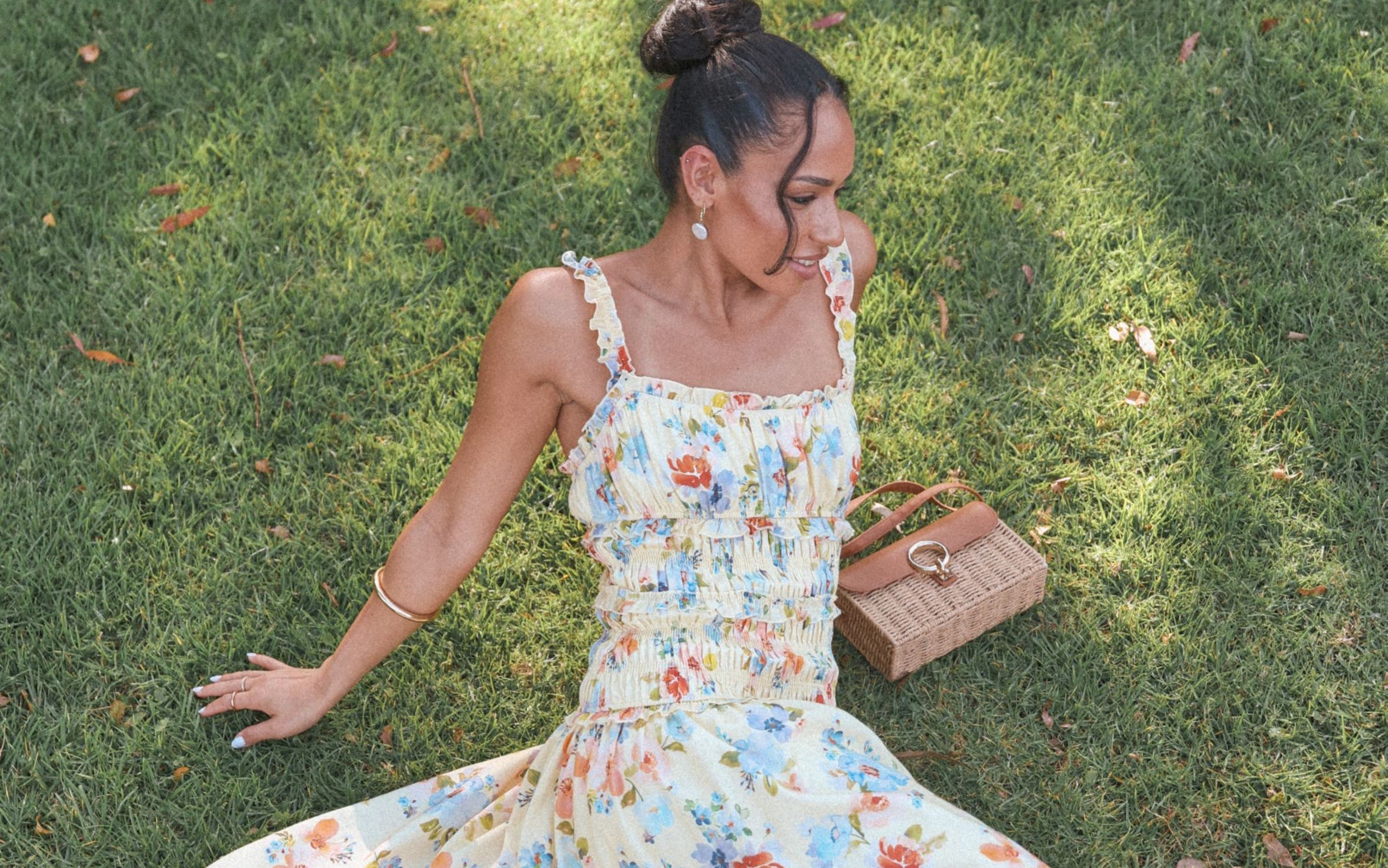 A woman wearing a smocked floral-print dress.