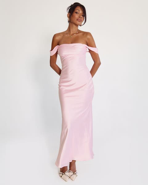 A woman wearing a pink off-the-shoulder gown.