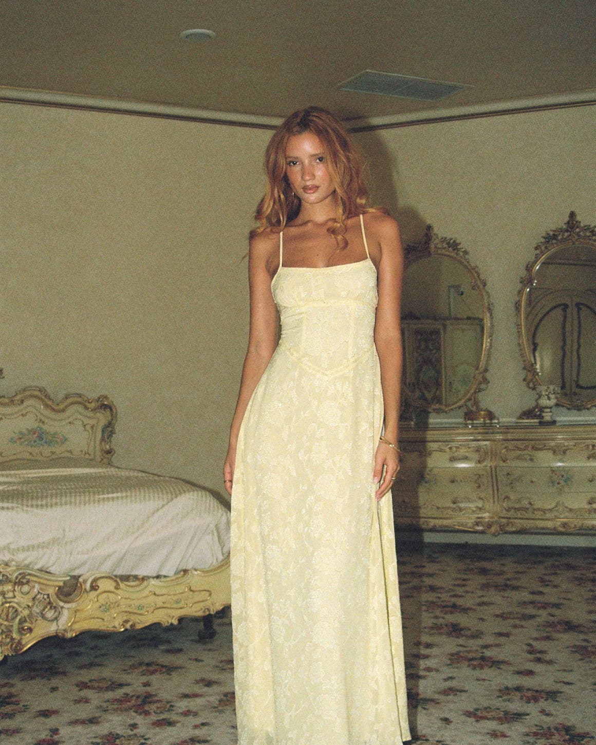 A woman wearing a yellow floor length dress.