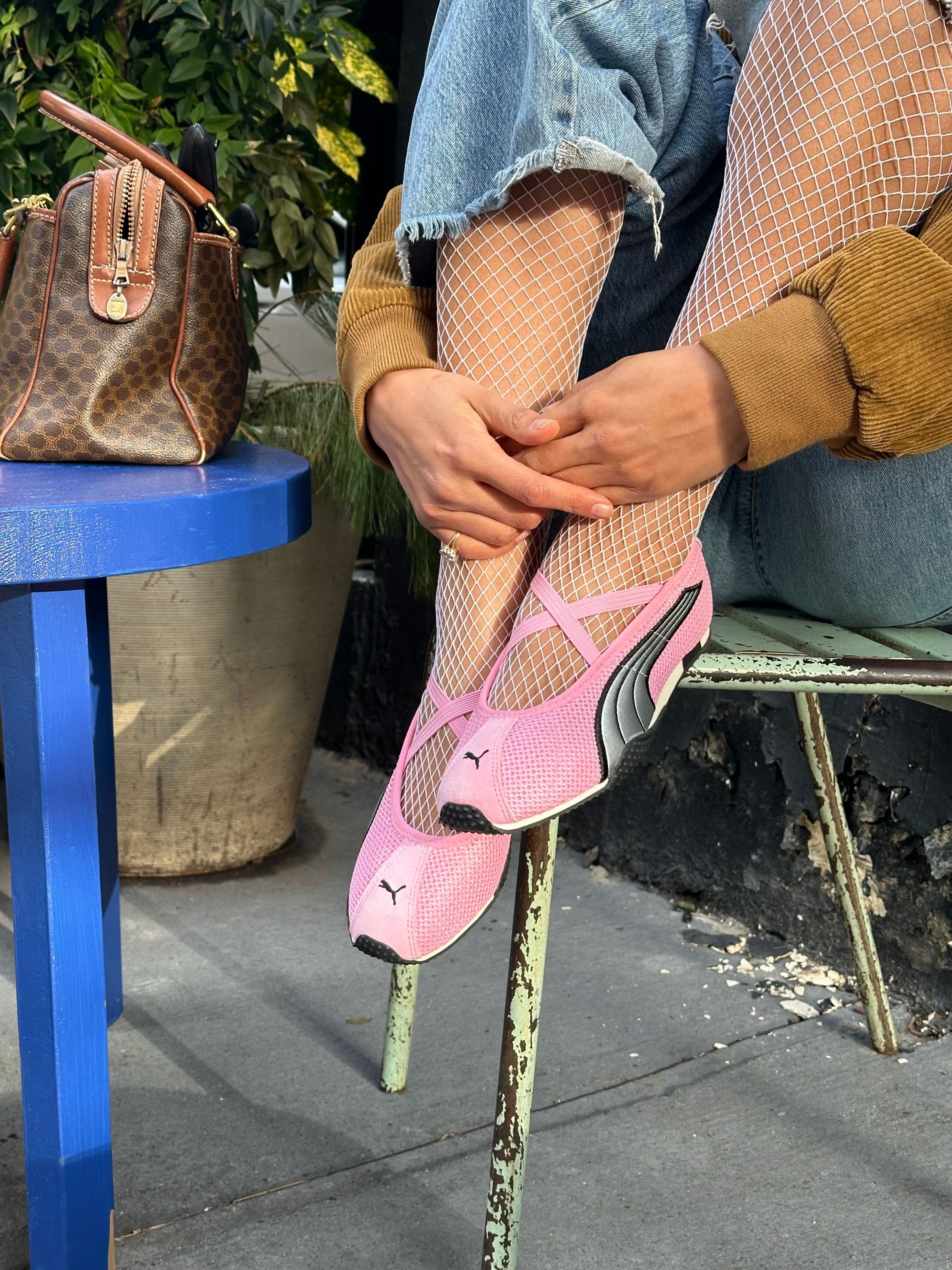 Woman wearing PUMA sneakers.