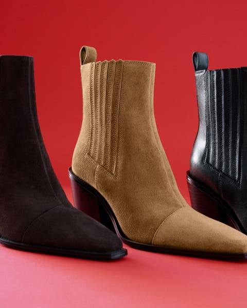 3 pairs of identical boots in front of a red background.