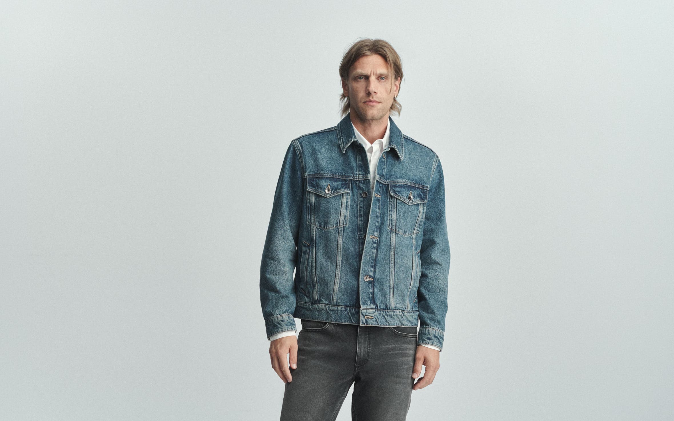 A man wearing rag & bone denim jacket and jeans.