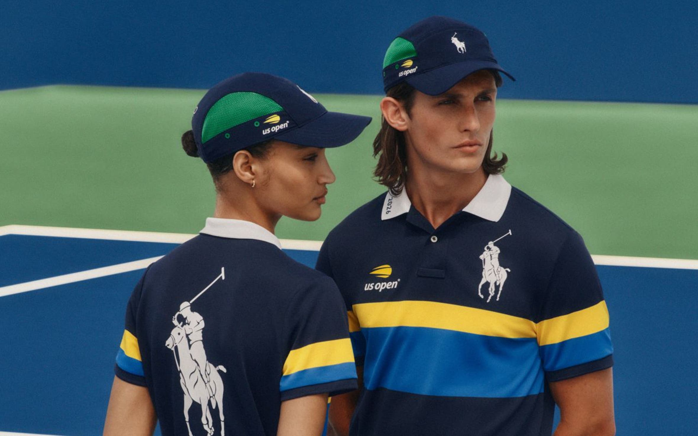 A man and woman wearing matching tennis outfits from the US Open x Polo Ralph Lauren collaboration.
