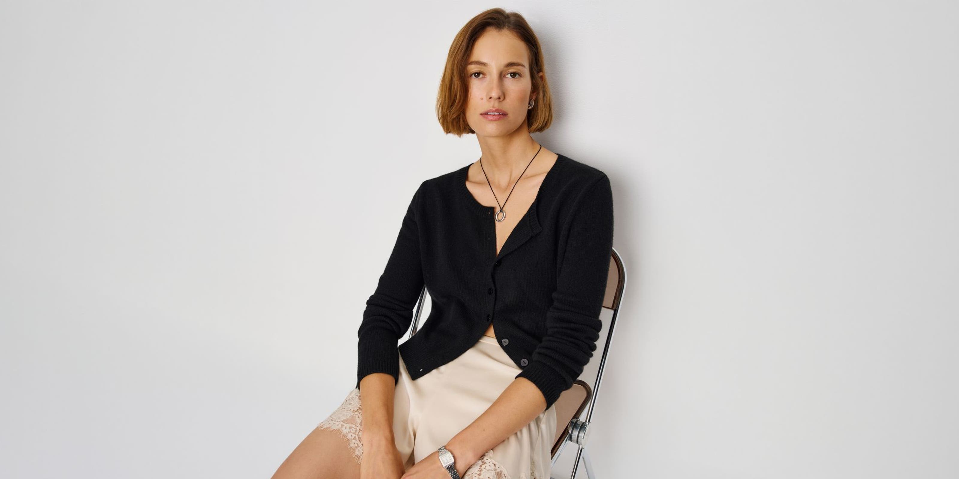 A woman wearing a Reformation cardigan.