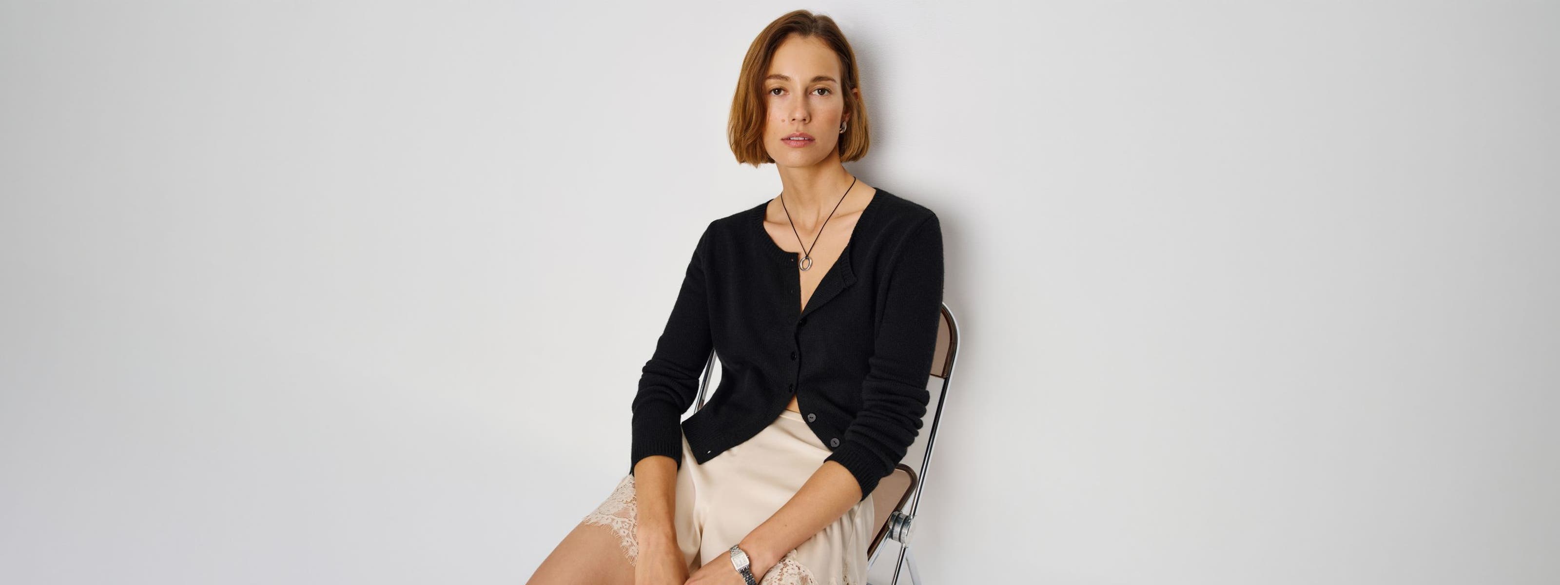 A woman wearing a Reformation cardigan.