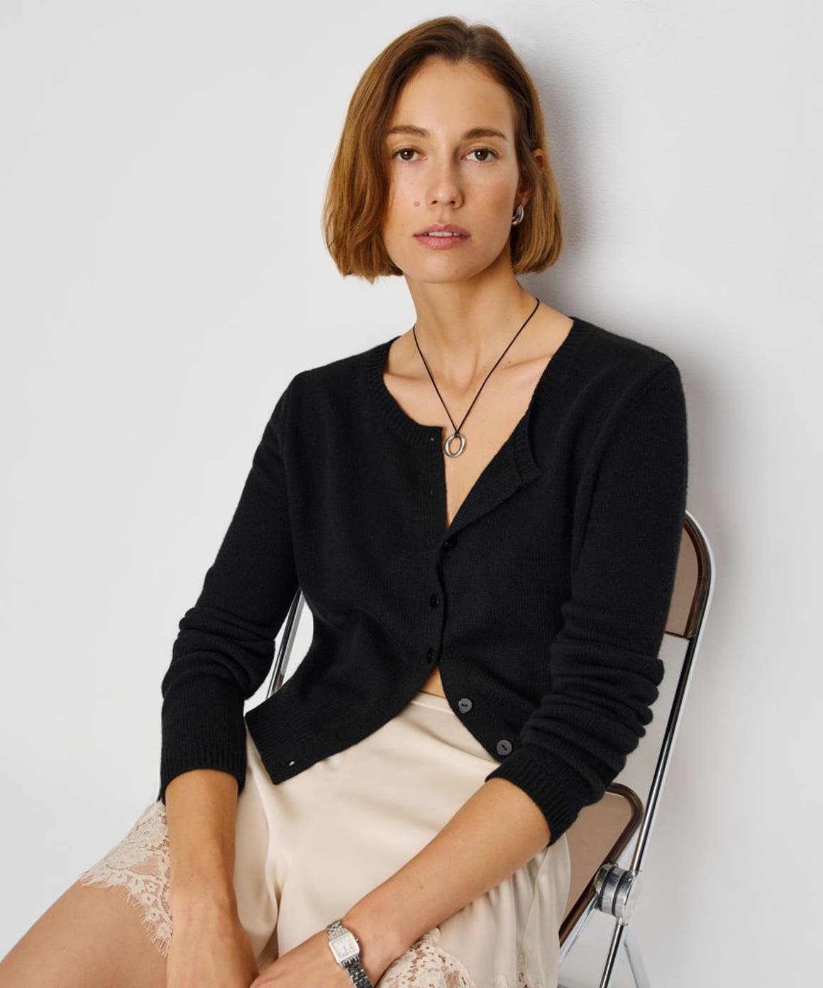 A woman wearing a Reformation cardigan.