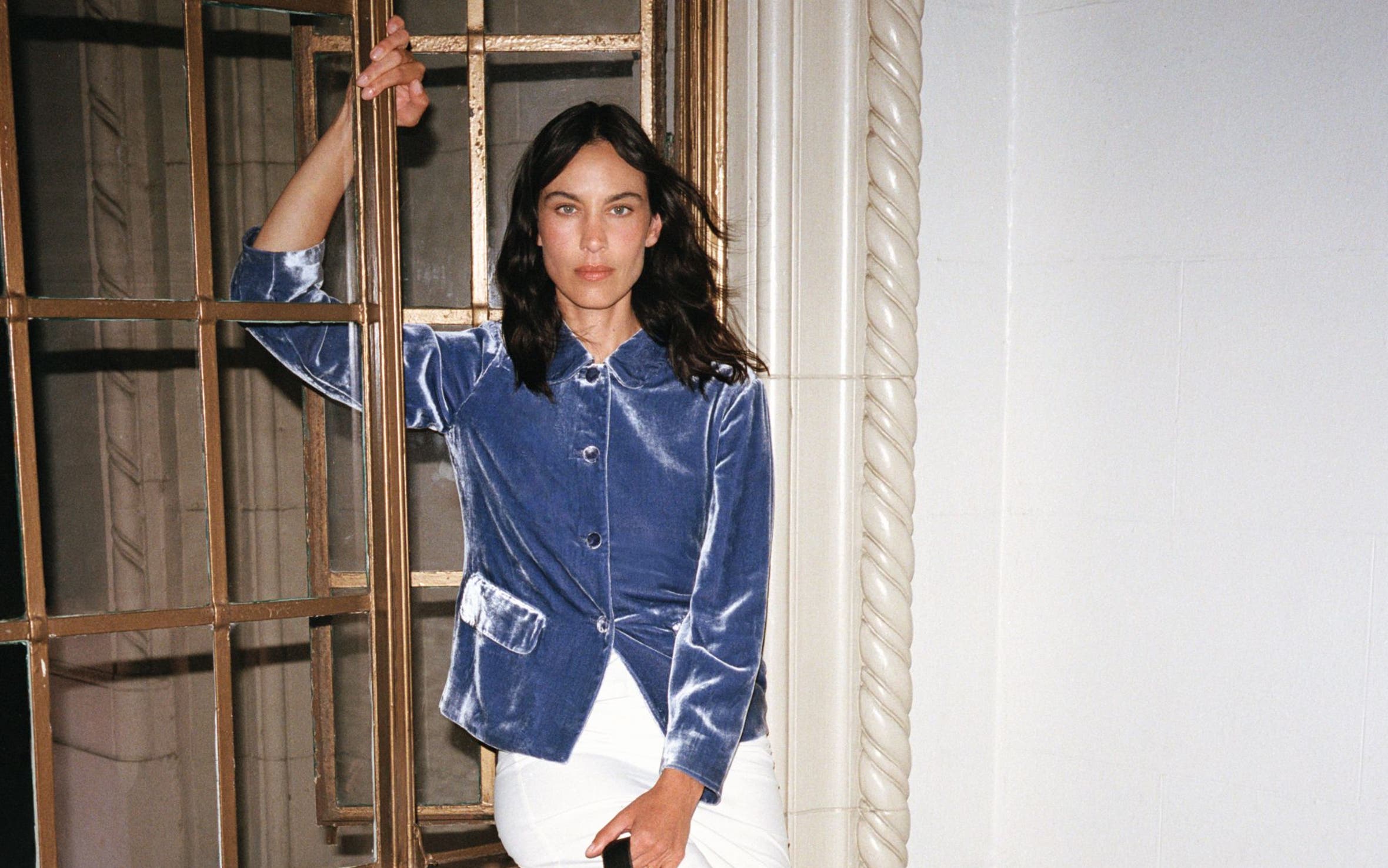 Alexa Chung wearing a blue velvet top and white skirt.