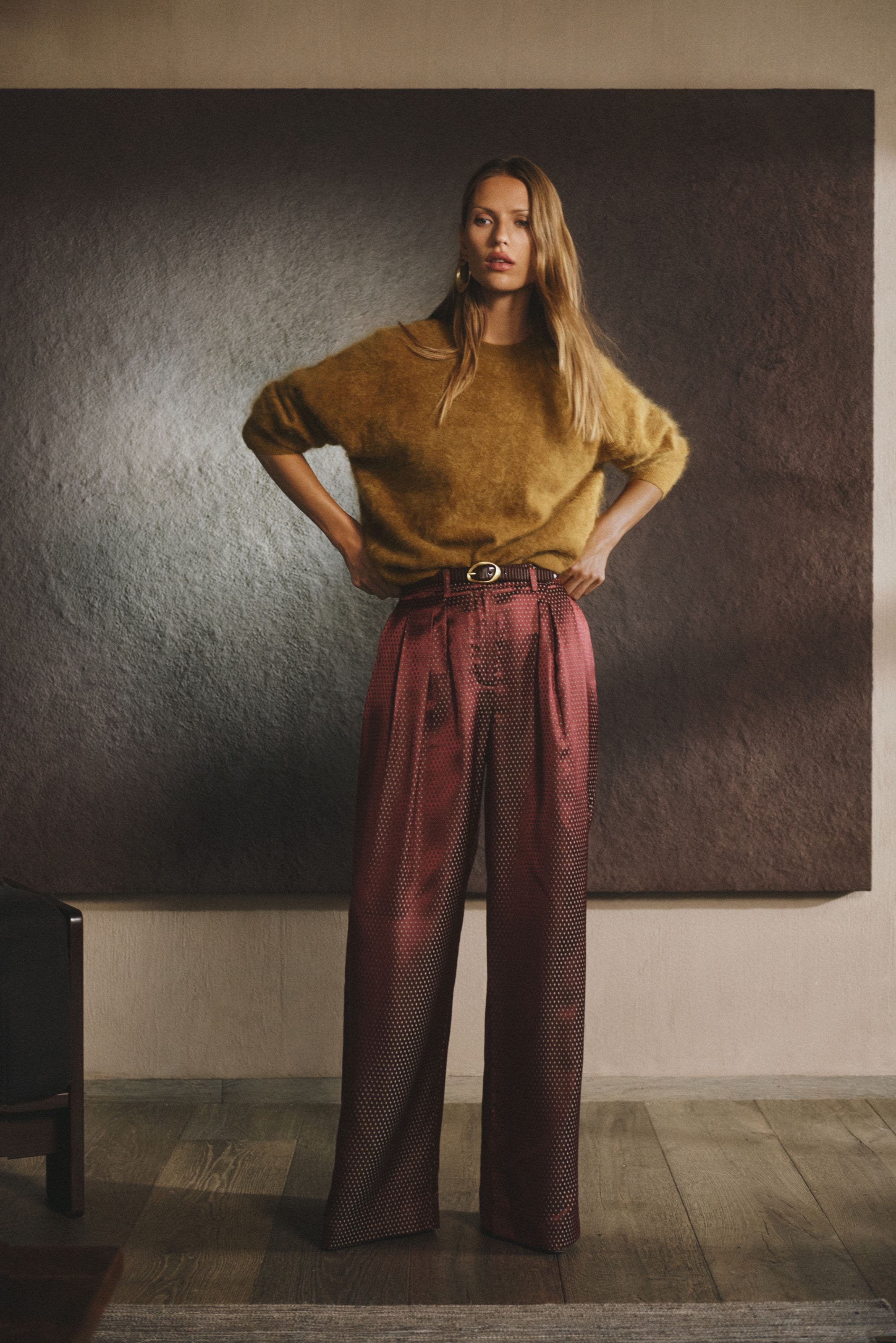 A woman in a mustard fuzzy sweater.