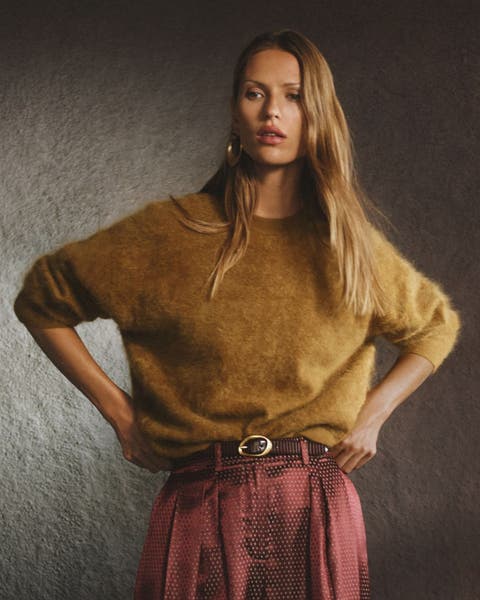 A woman in a mustard fuzzy sweater.
