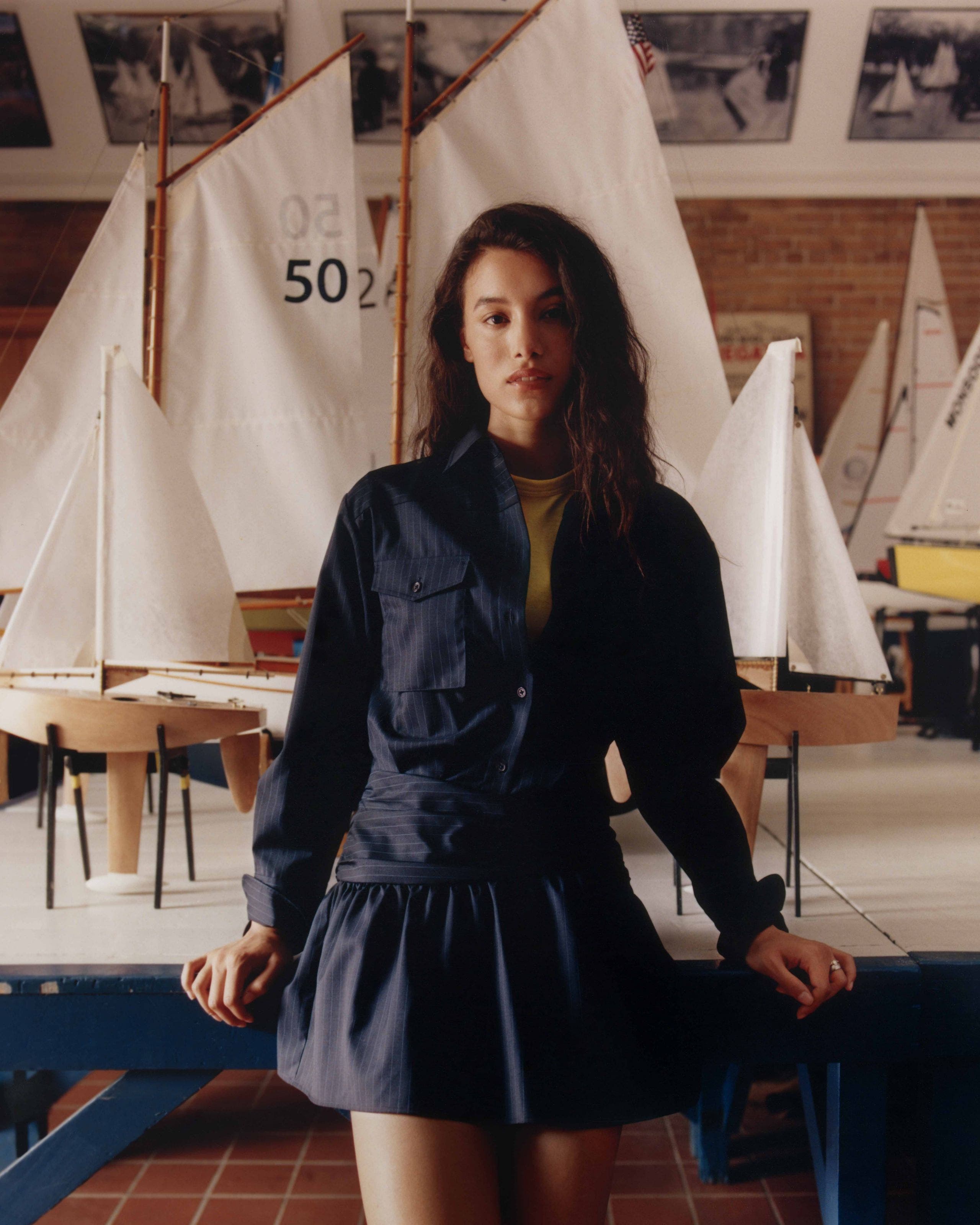 A woman wearing a navy blue cotton dress.