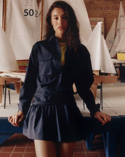 A woman wearing a navy blue cotton dress.