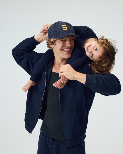 A man with a small kid on his shoulders.