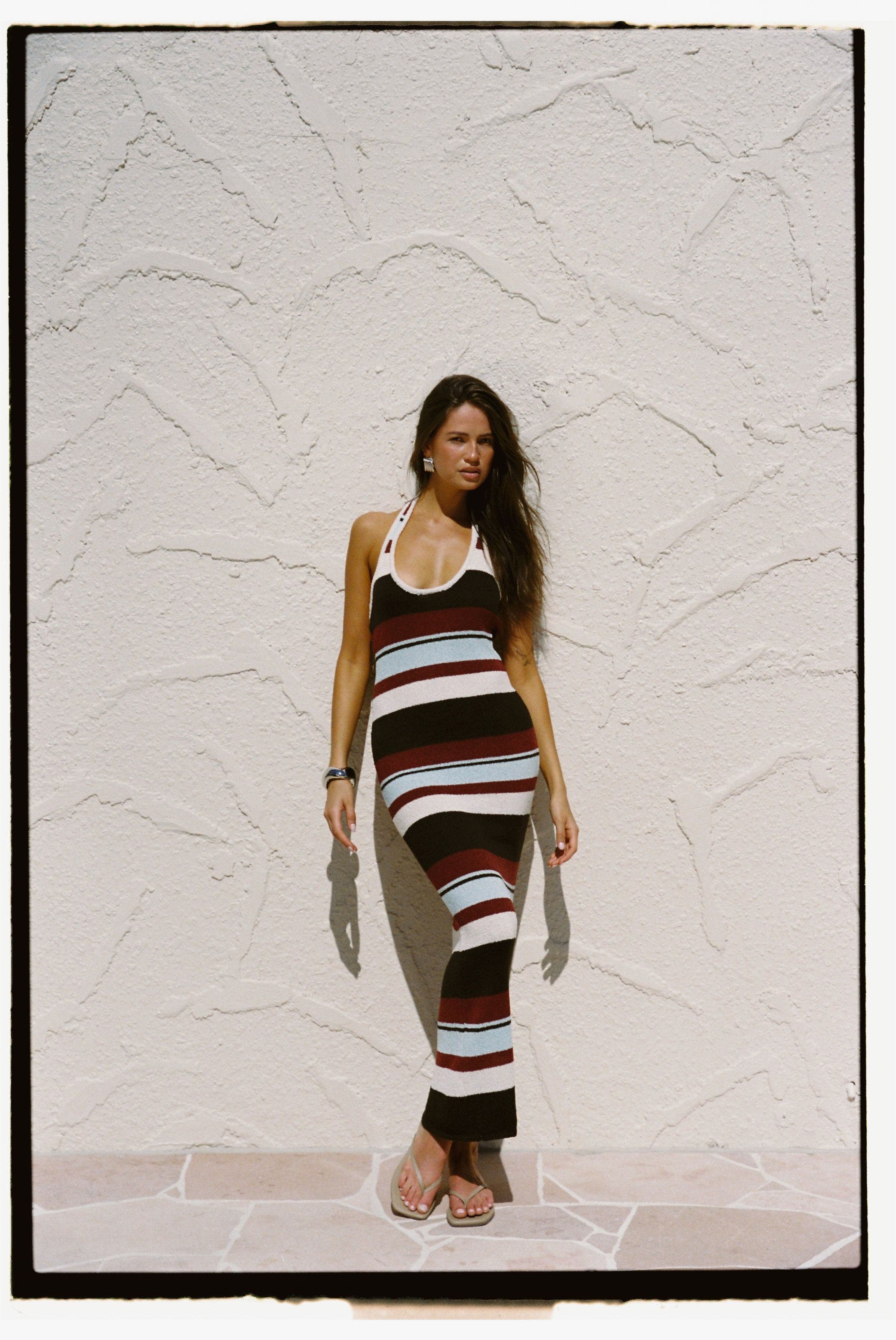 A woman wearing a knit halter maxi dress.