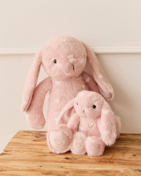 A pair of pink heart-print bunny studded animals.