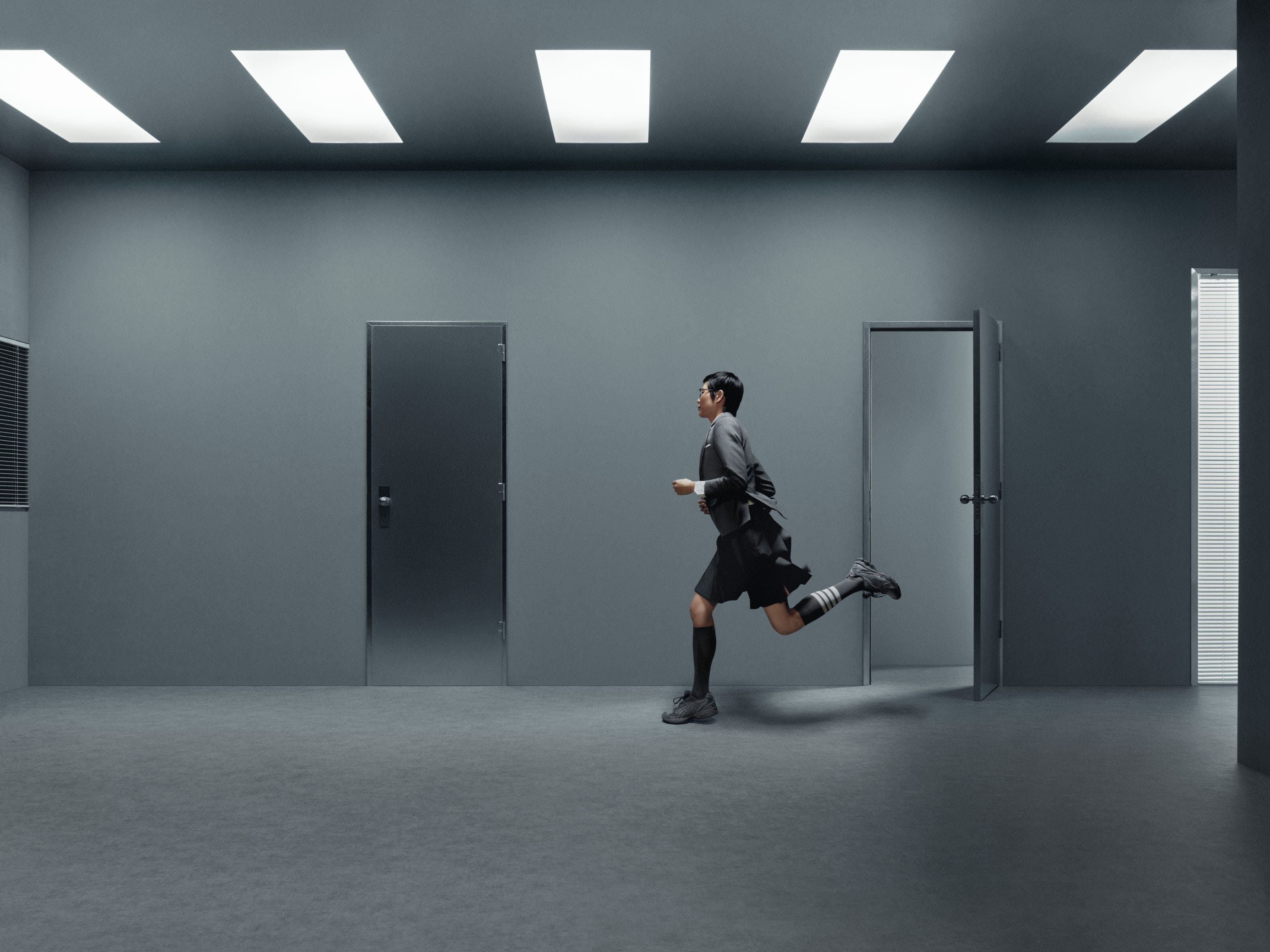 Model wearing Thom Browne x ASICS sneakers.