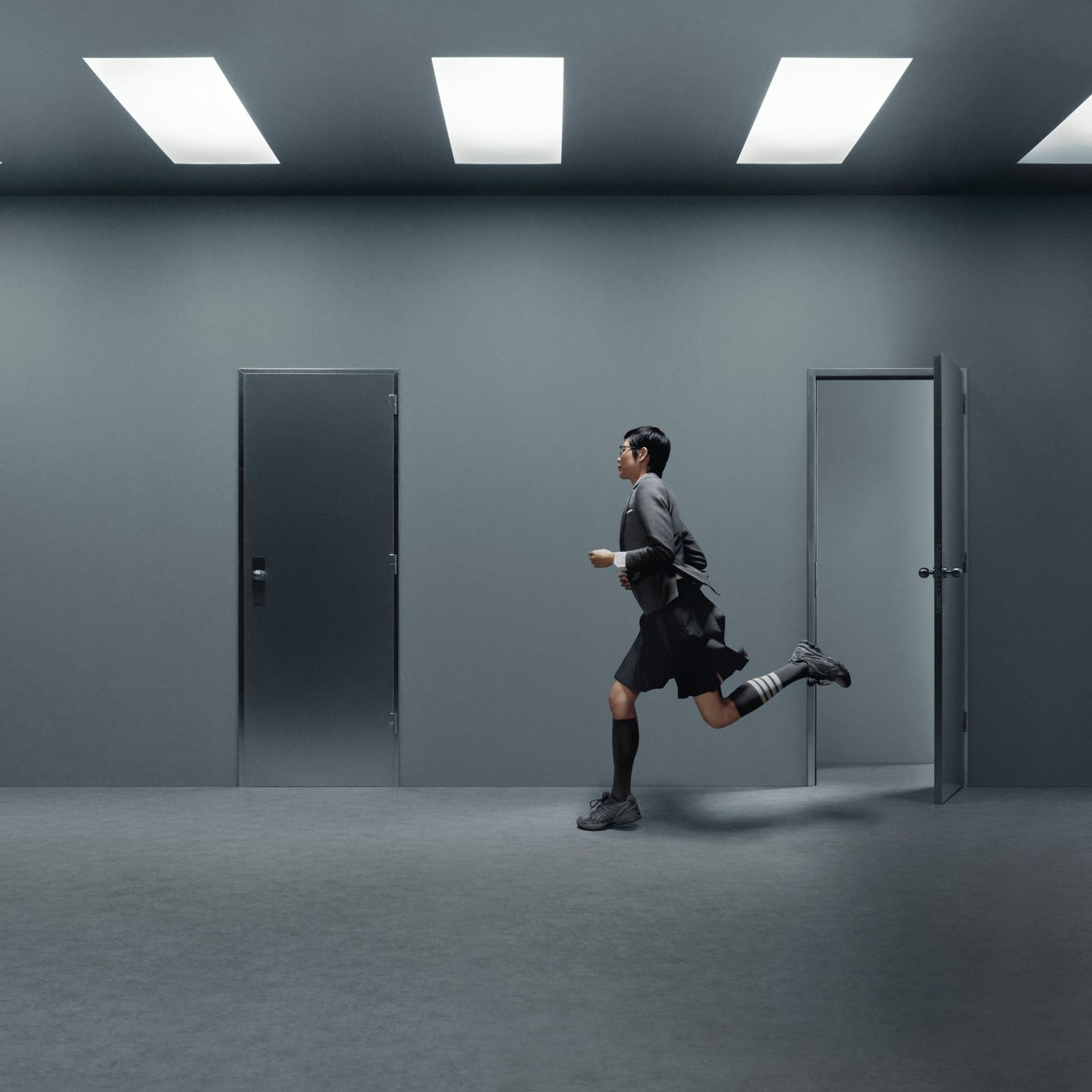 Model wearing Thom Browne x ASICS sneakers.