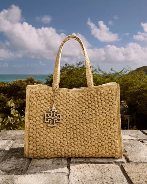 A woven Tory Burch handbag. 