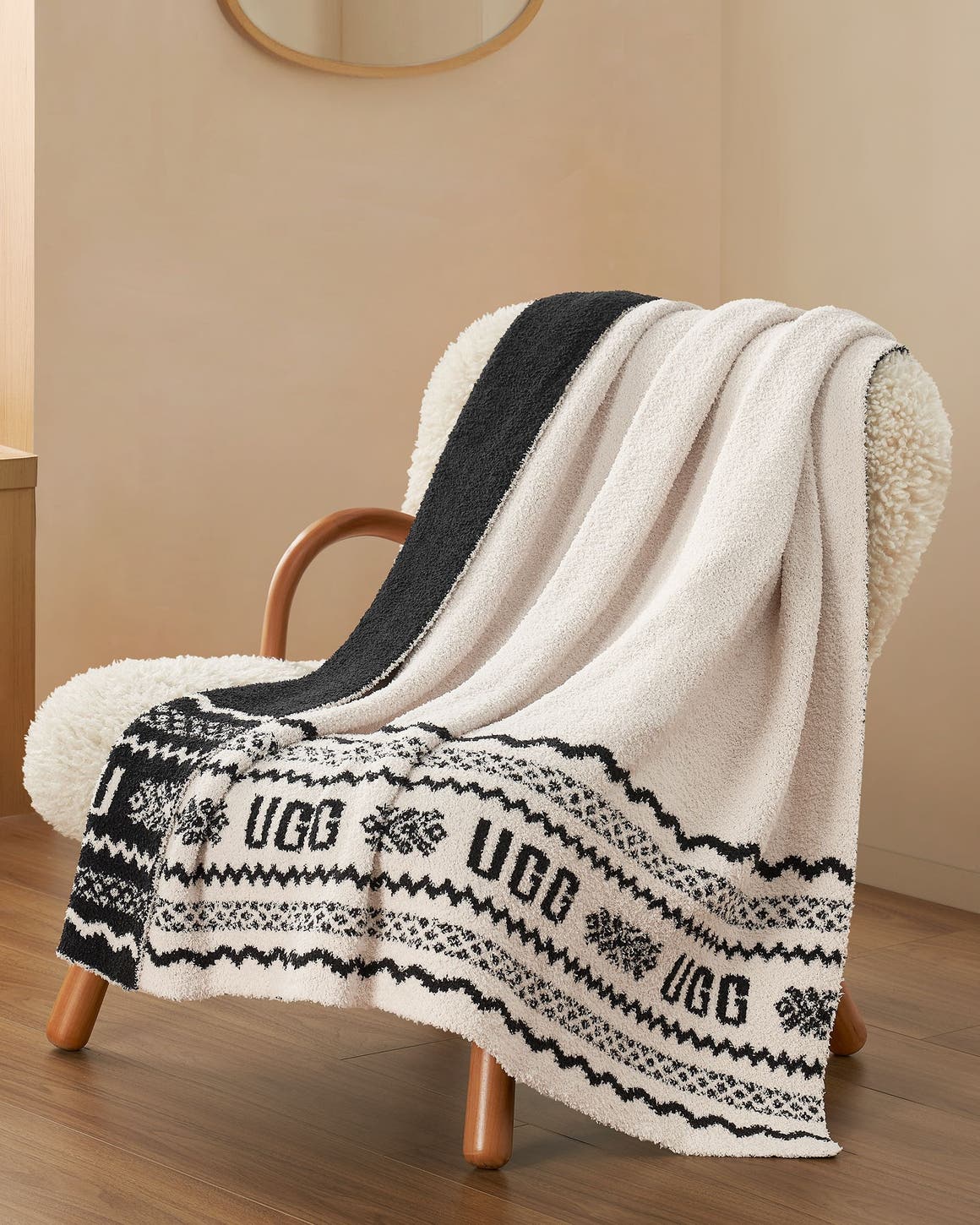 An UGG throw blanket draped over a chair.