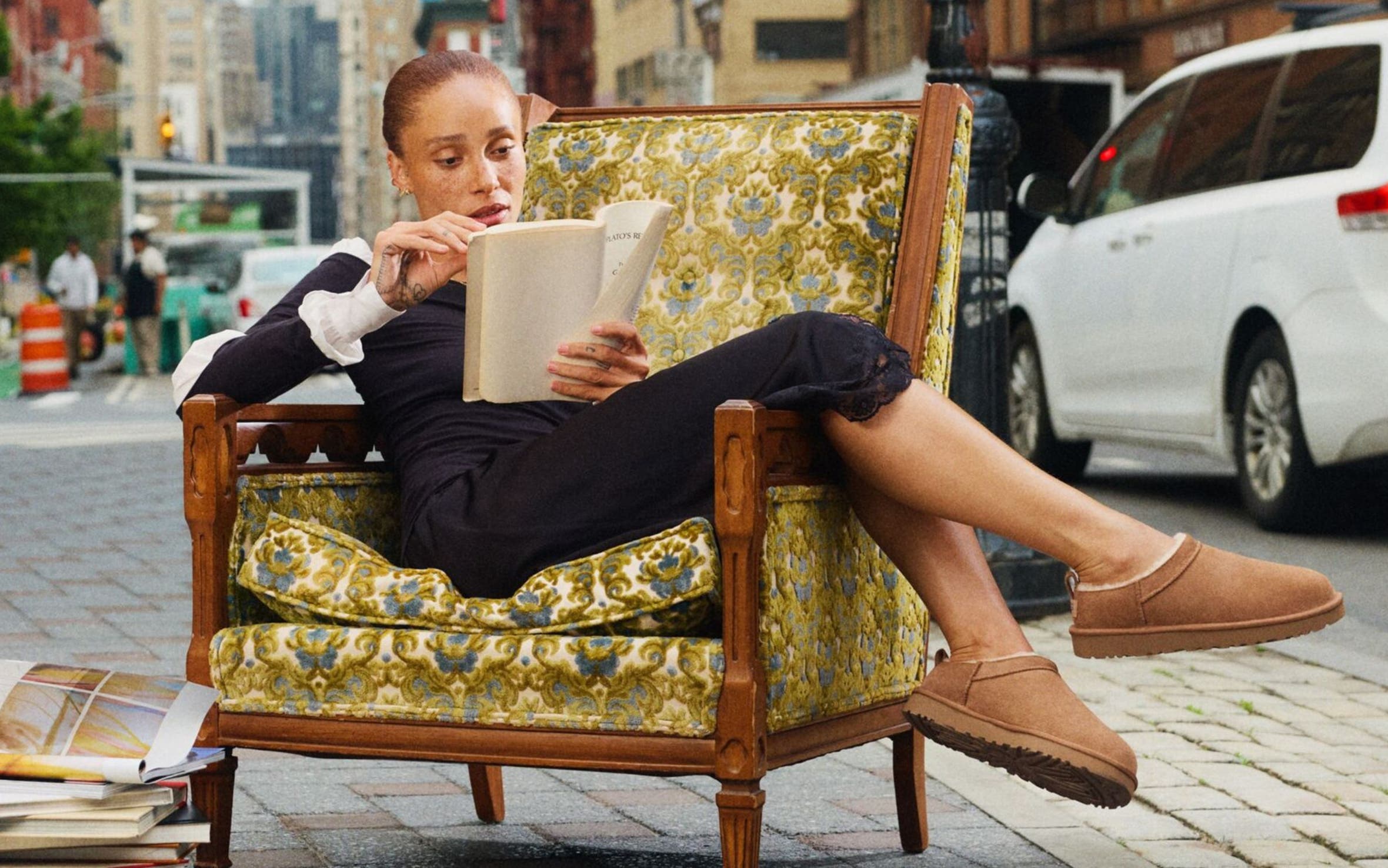 Woman wearing UGGs sitting on a chair.